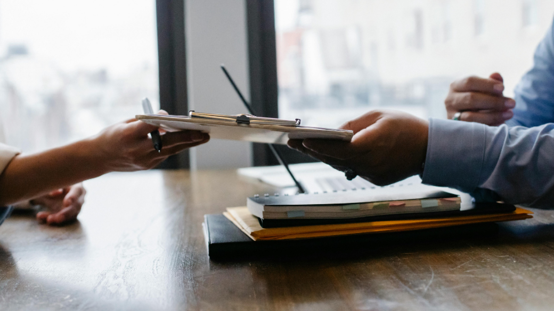 General image for employment - two hands exchanging a file